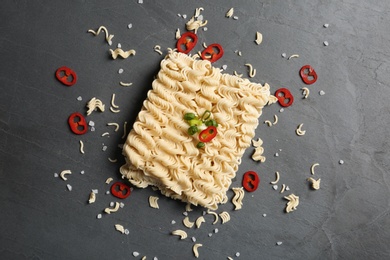 Photo of Flat lay composition with quick cooking noodles on color background