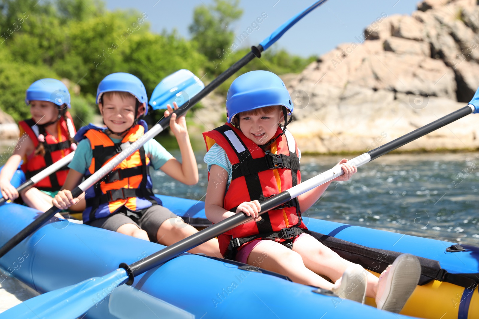 Photo of Little children kayaking on river. Summer camp