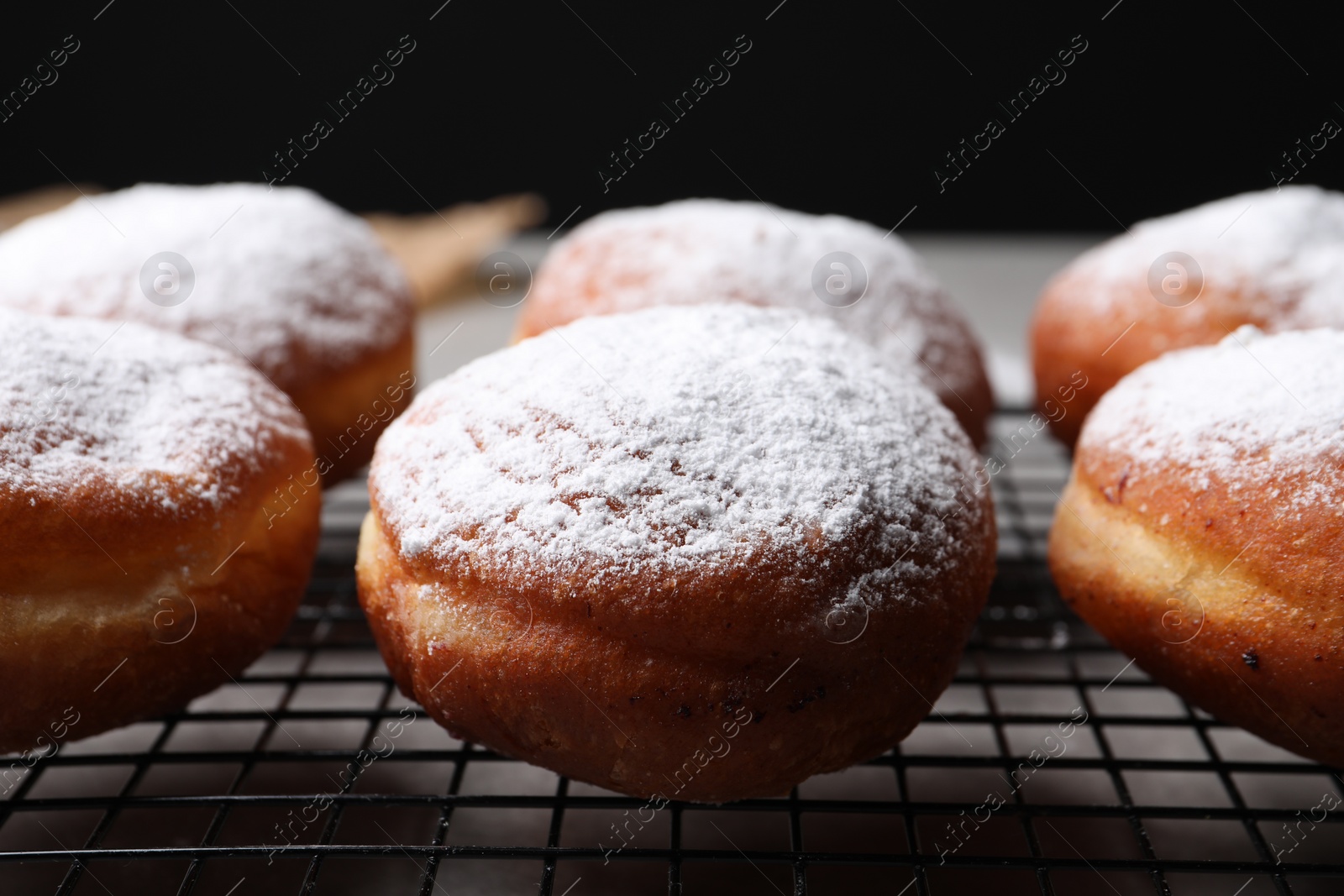 Photo of Delicious sweet buns on table against black background, closeup