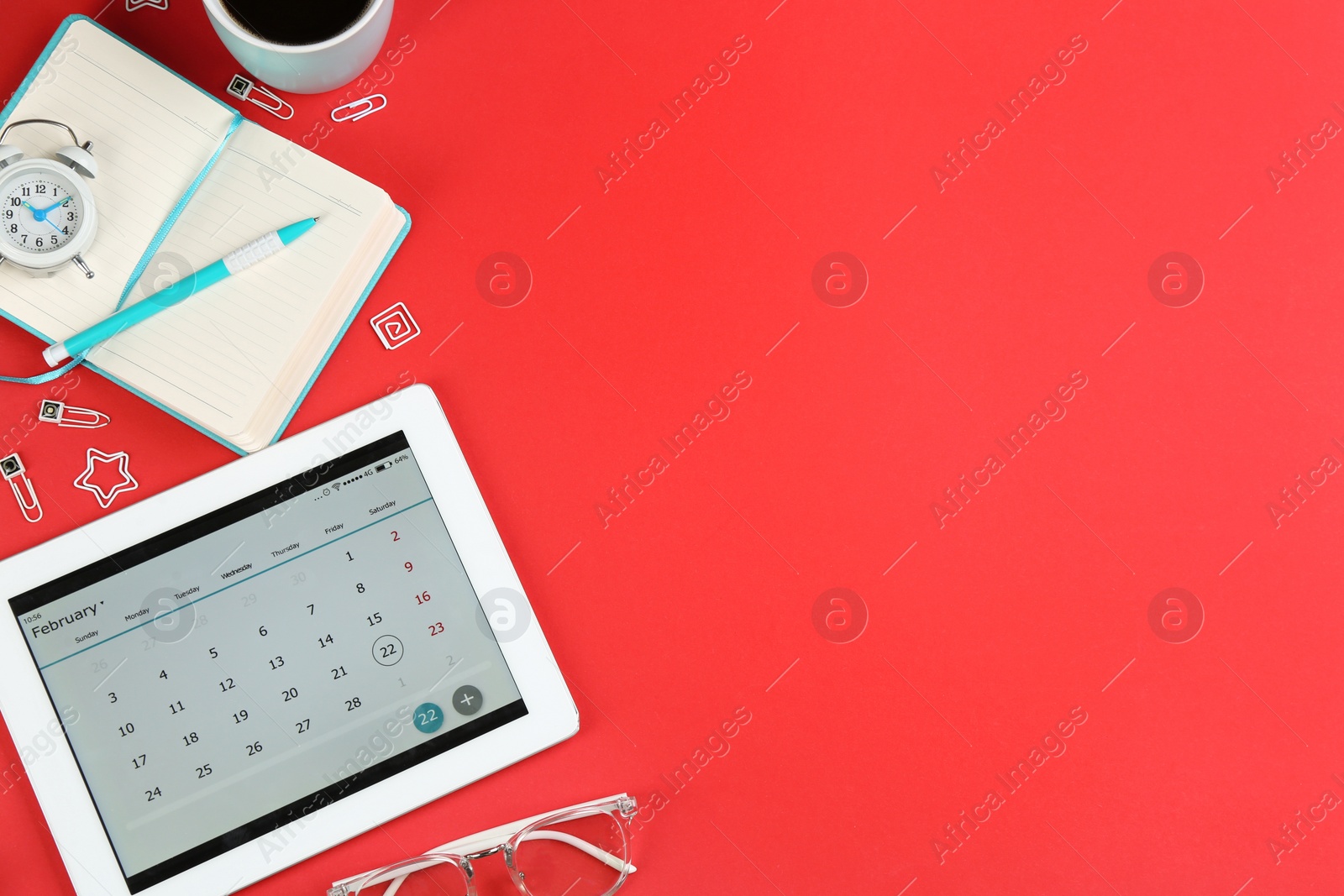 Photo of Modern tablet with calendar app on red background, flat lay. Space for text
