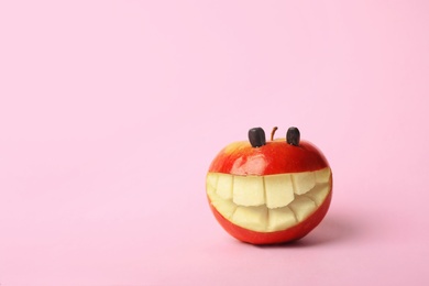 Funny smiling apple on color background. Space for text