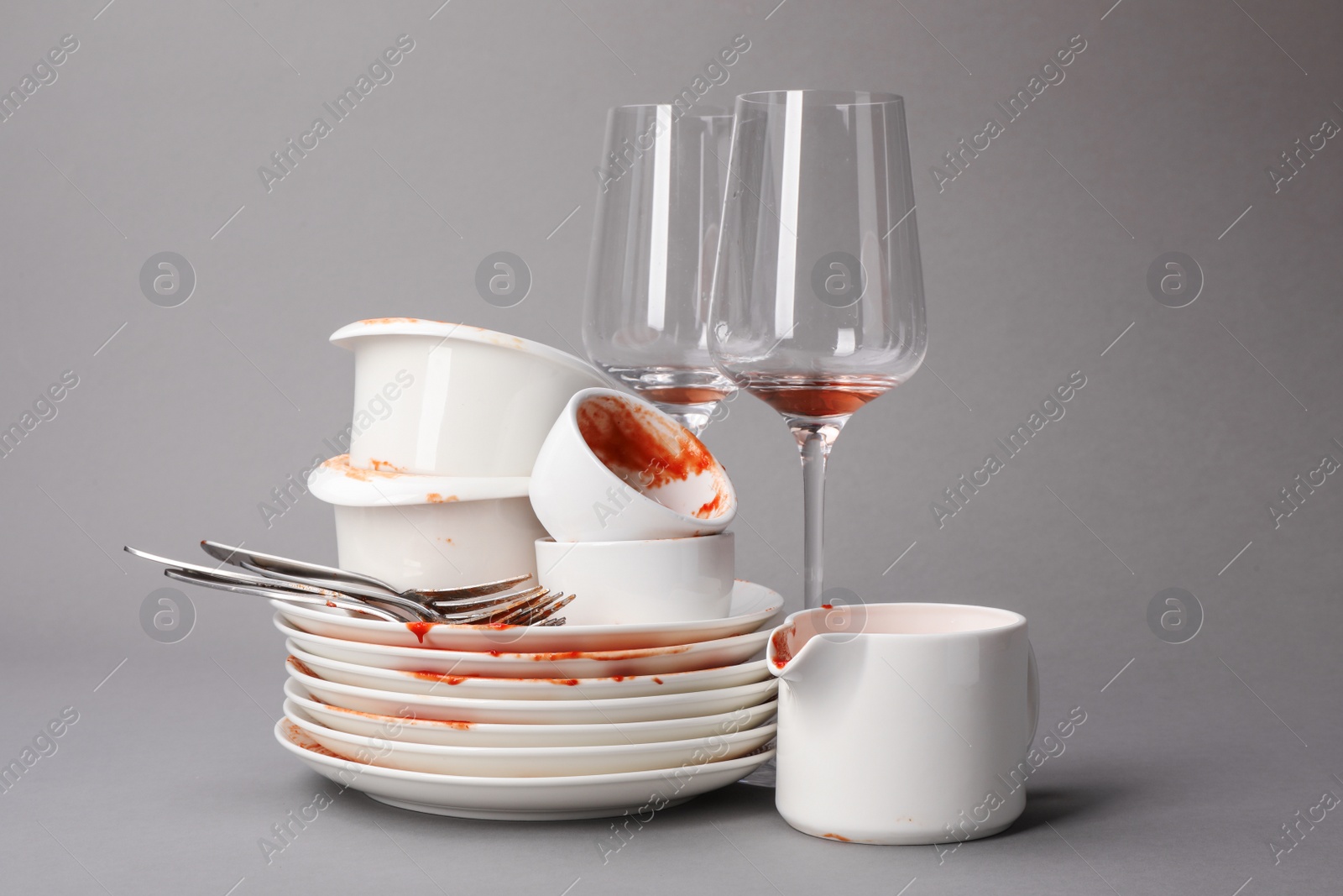 Photo of Set of dirty dishes on grey background