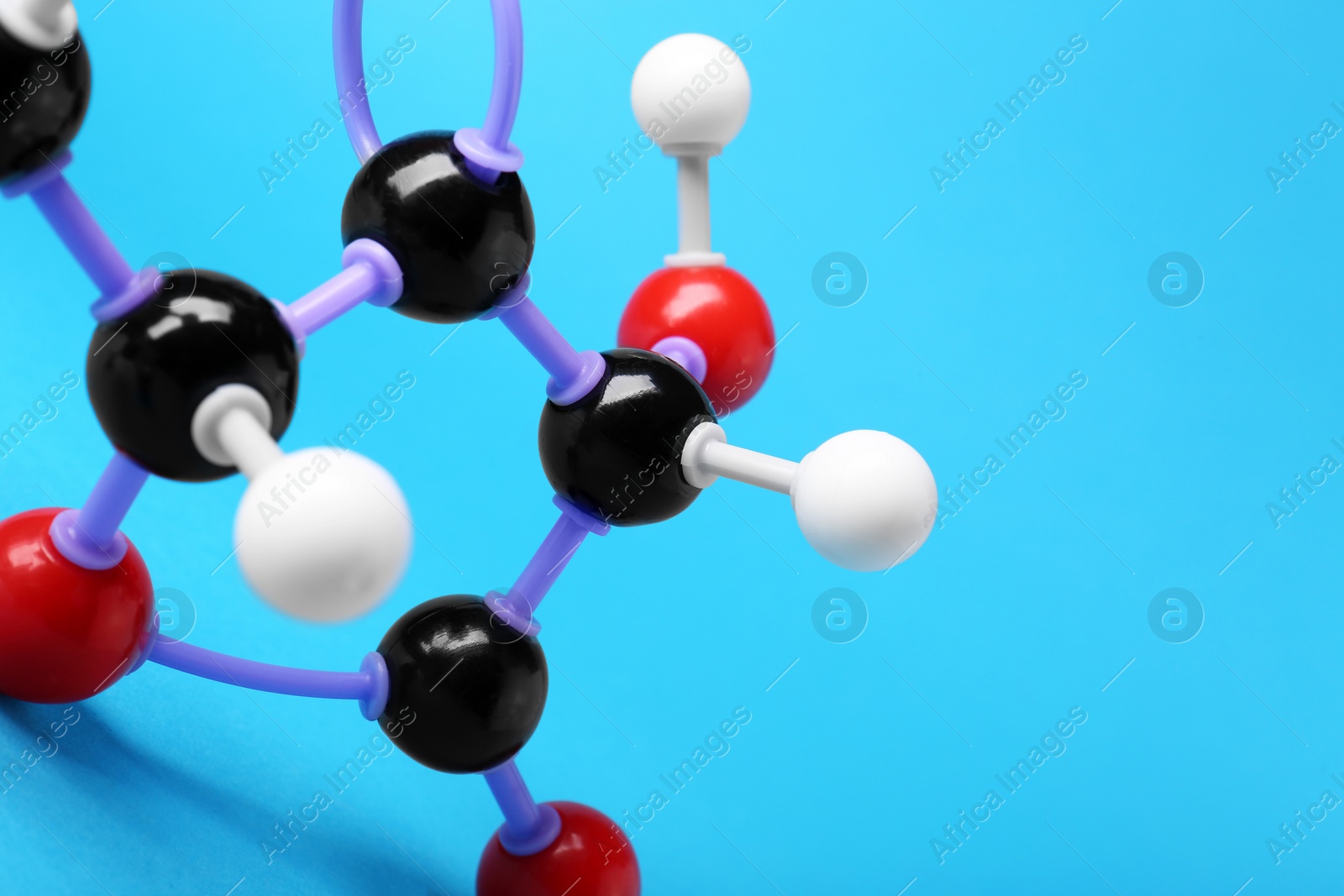 Photo of Closeup view of vitamin C molecule on light blue background, space for text. Chemical model