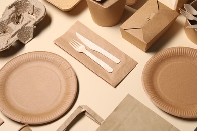 Eco friendly food packaging. Paper containers and tableware on beige background