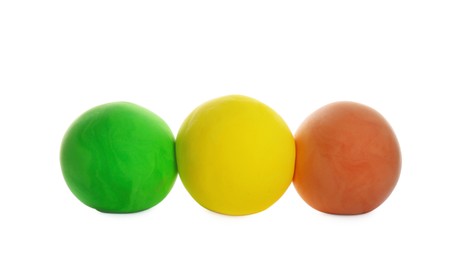 Photo of Row of color play dough balls isolated on white