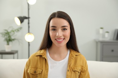 Photo of Portrait of happy young woman in room