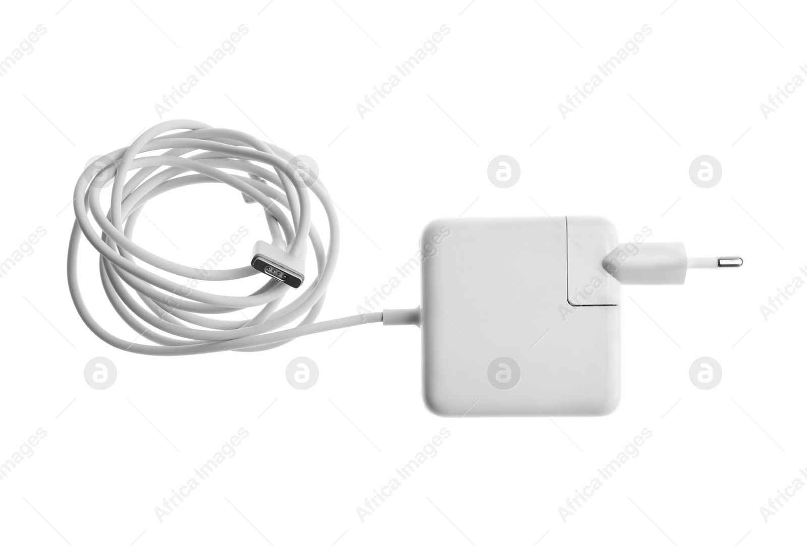 Photo of Laptop charger isolated on white, top view. Modern technology