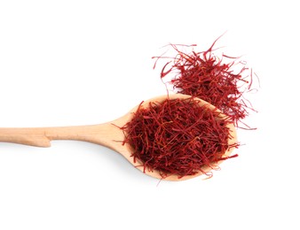 Photo of Dried saffron and wooden spoon on white background, top view