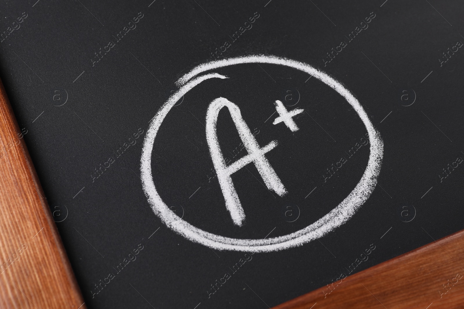 Photo of School grade. Letter A with plus symbol on blackboard, closeup