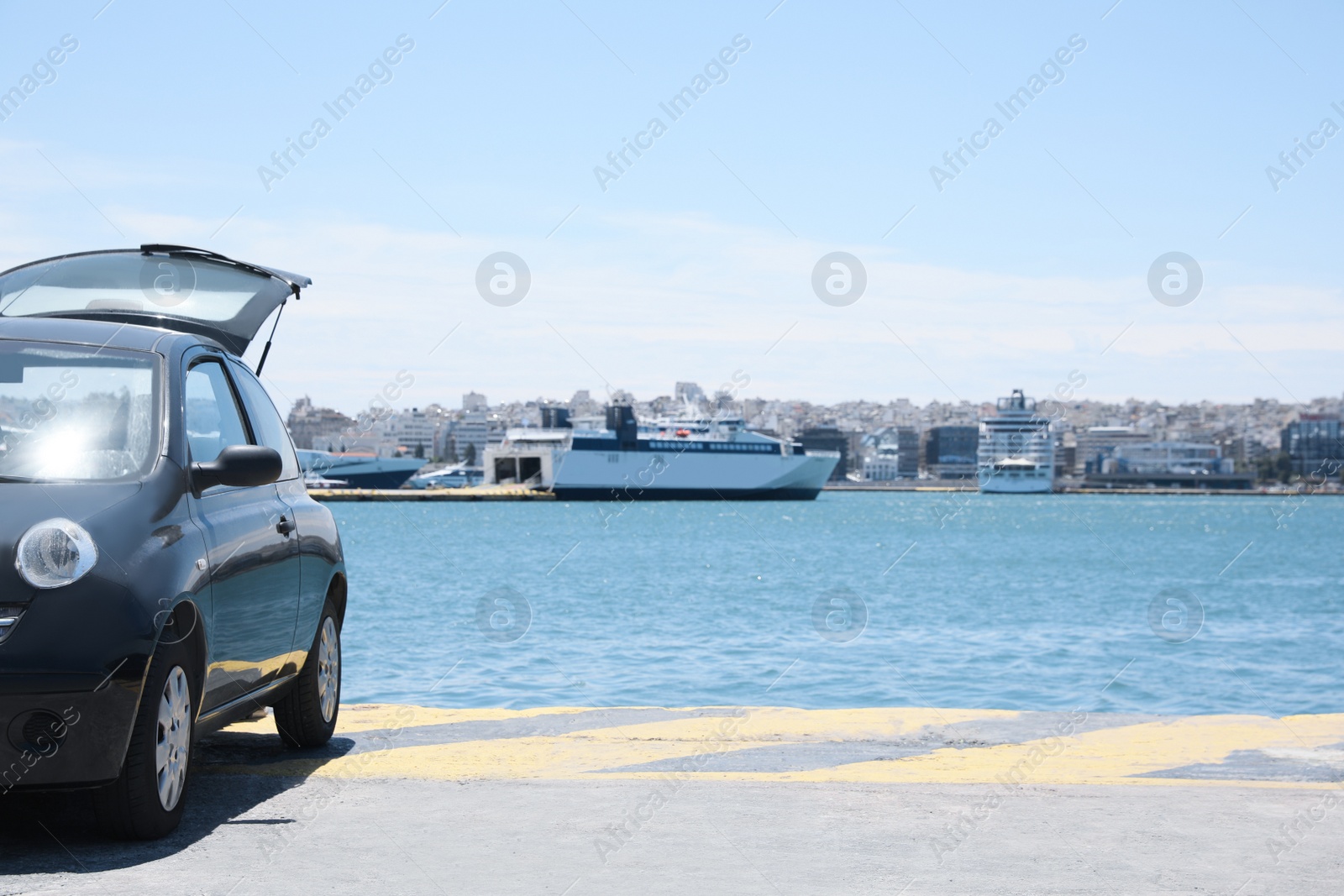 Photo of Black modern car on pier near sea port