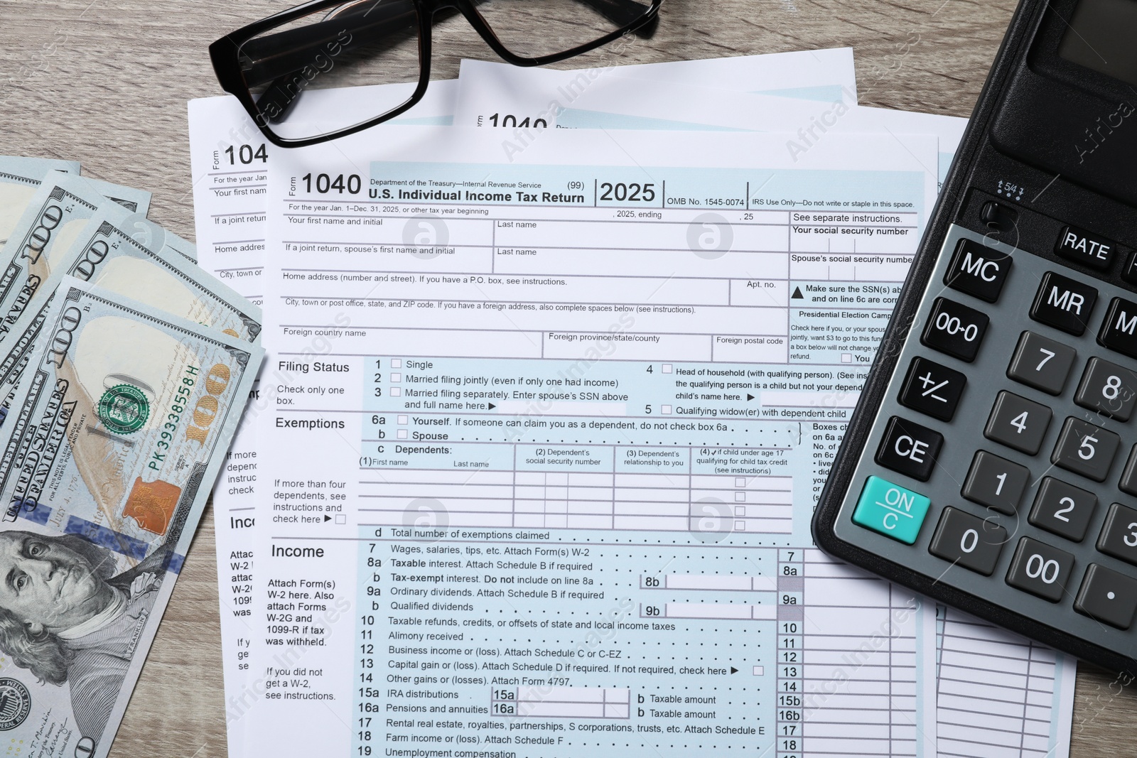 Photo of Payroll. Tax return forms, dollar banknotes, glasses and calculator on wooden table, flat lay