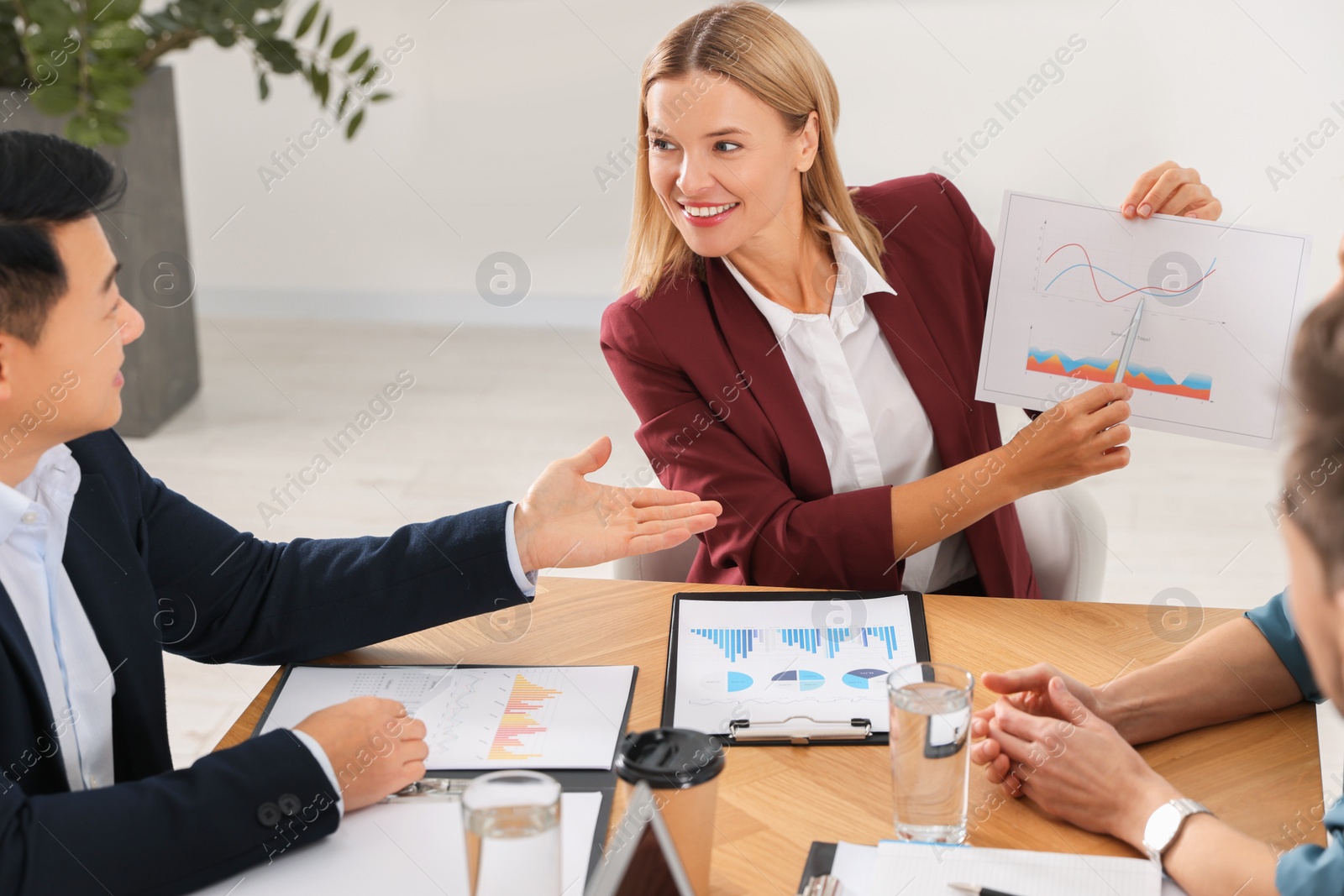 Photo of Businesswoman showing chart on meeting in office