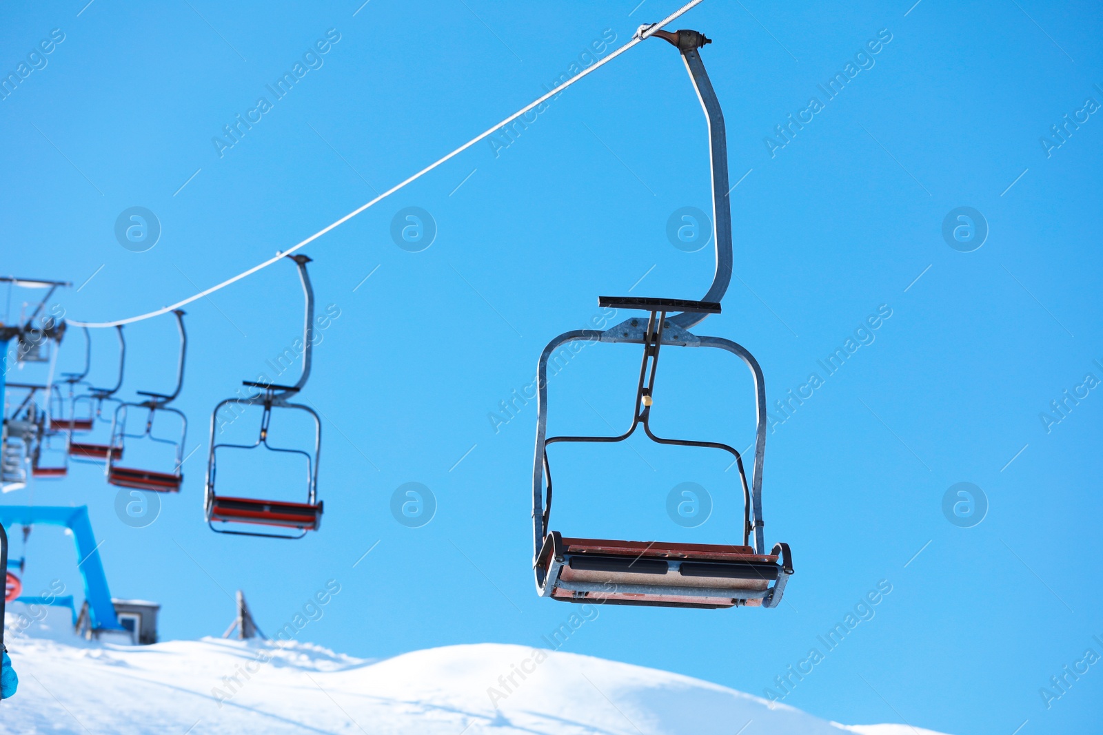 Photo of Empty chairlift at mountain ski resort. Winter vacation