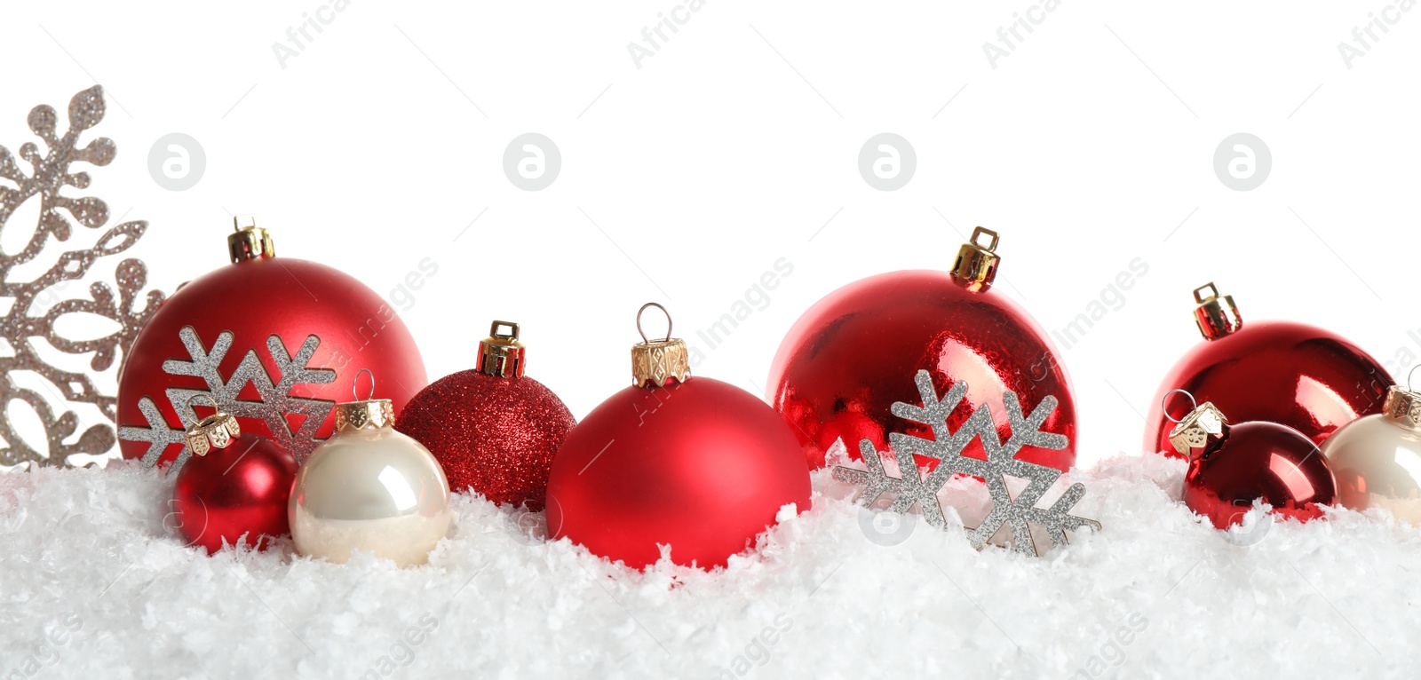 Photo of Christmas tree decoration on artificial snow against white background