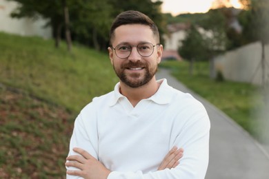 Photo of Portrait of handsome bearded man in glasses outdoors