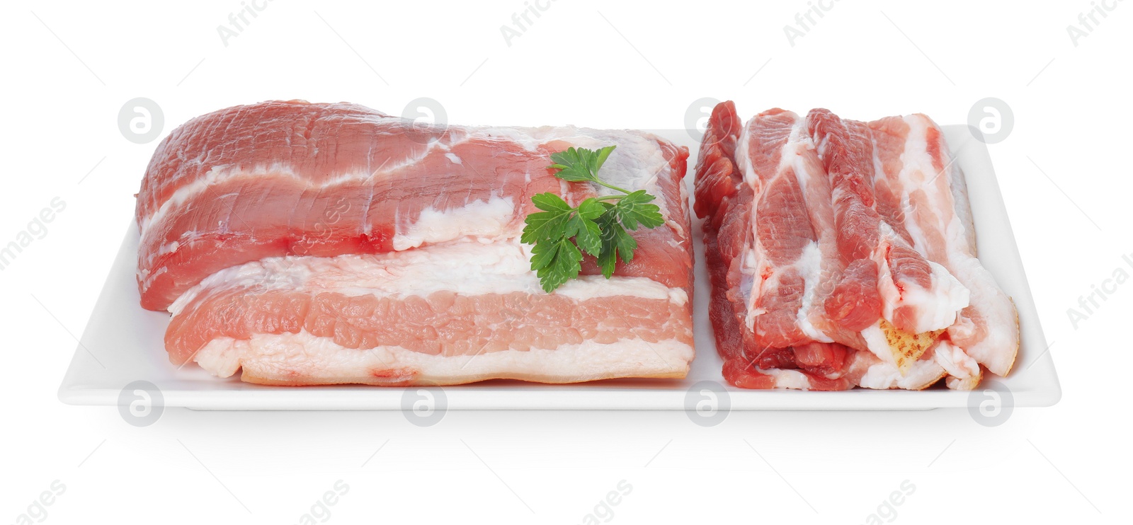 Photo of Pieces of raw pork belly and parsley isolated on white