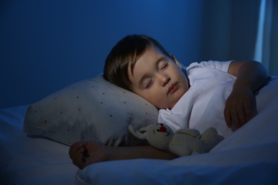 Photo of Cute little baby sleeping with toy at home. Bedtime