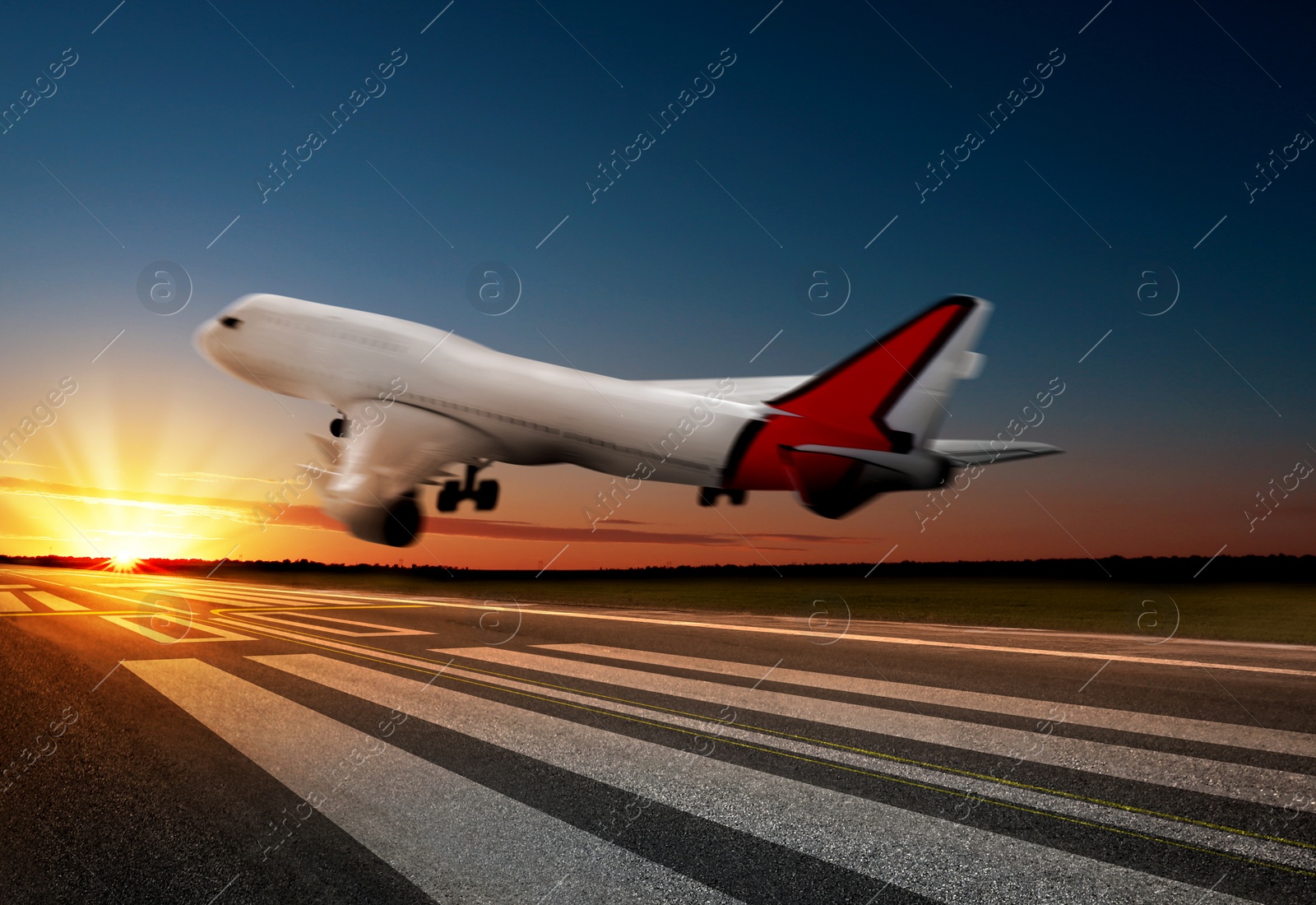 Image of Modern white airplane landing on runway 