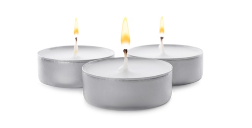 Photo of Three small wax candles isolated on white