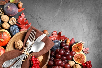 Photo of Flat lay composition with cutlery, autumn vegetables and fruits on grey background, space for text. Happy Thanksgiving day