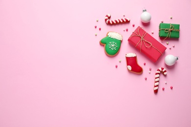 Flat lay composition with Christmas decorations on pink background, space for text