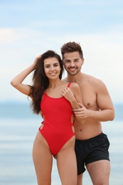 Photo of Happy young couple spending time together on beach