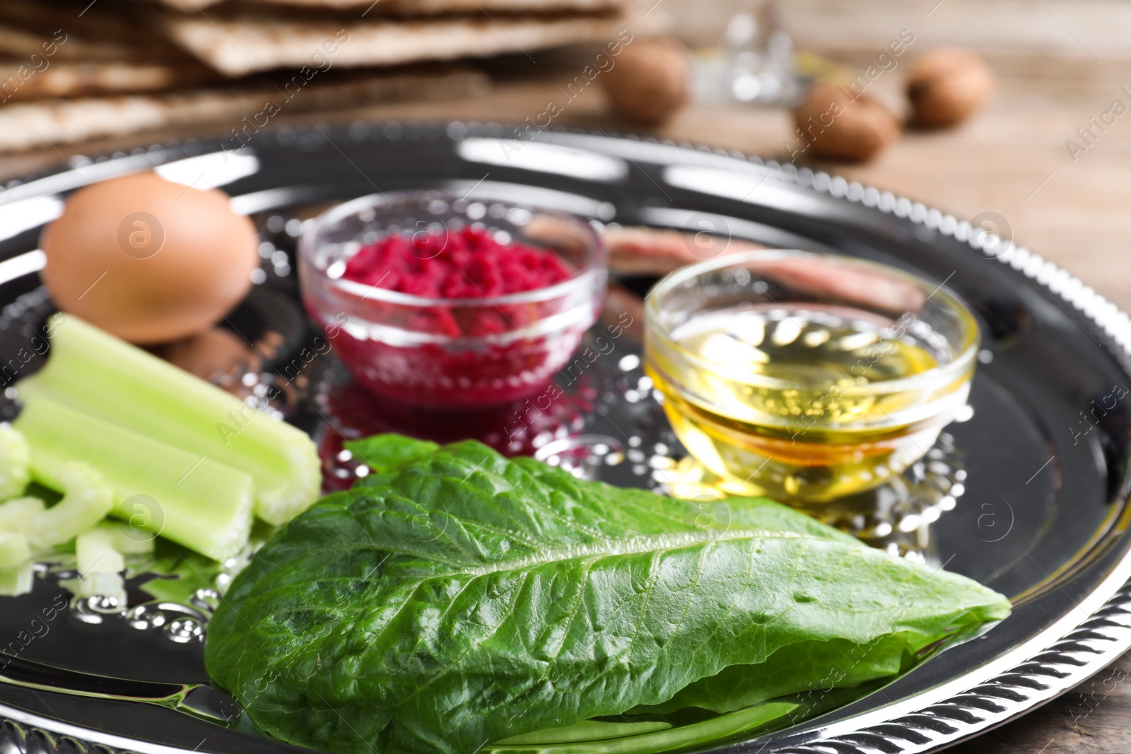 Photo of Closeup view of Passover Seder plate (keara) with traditional meal. Pesah celebration