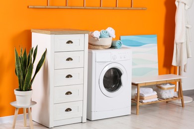 Stylish laundry room with washing machine. Interior design