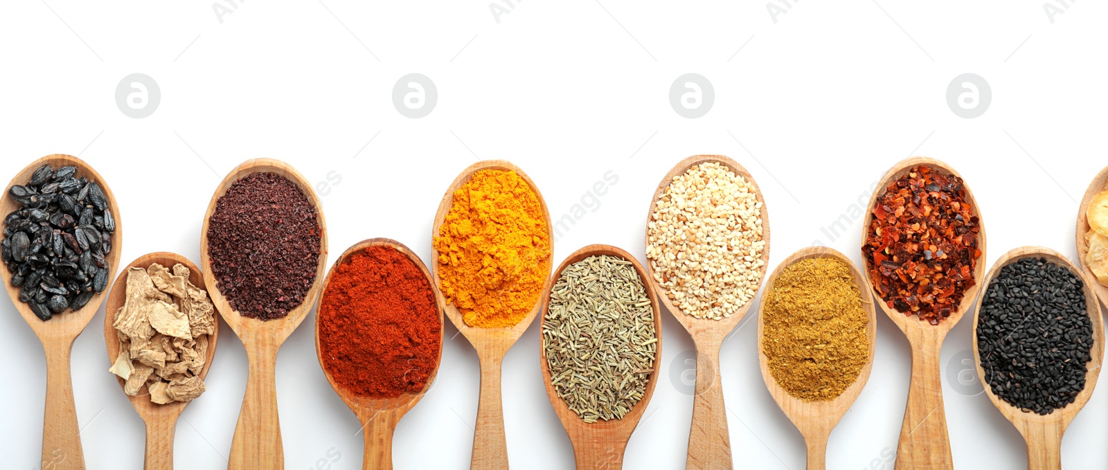 Photo of Composition with different aromatic spices in wooden spoons on white background