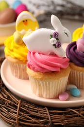 Photo of Tasty cupcakes with Easter decor on table