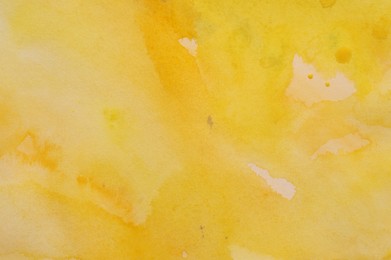 Abstract yellow watercolor painting as background, top view