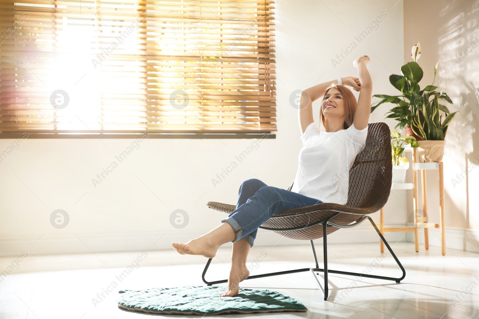 Photo of Young woman relaxing near window at home. Space for text