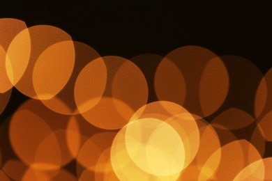 Photo of Beautiful golden lights on dark background. Bokeh effect