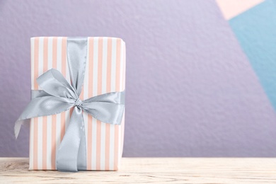 Elegant gift box with bow on table