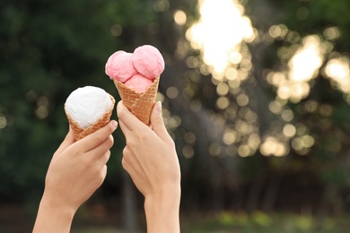 Photo of Women with ice cream spending time together outdoors, closeup. Space for text