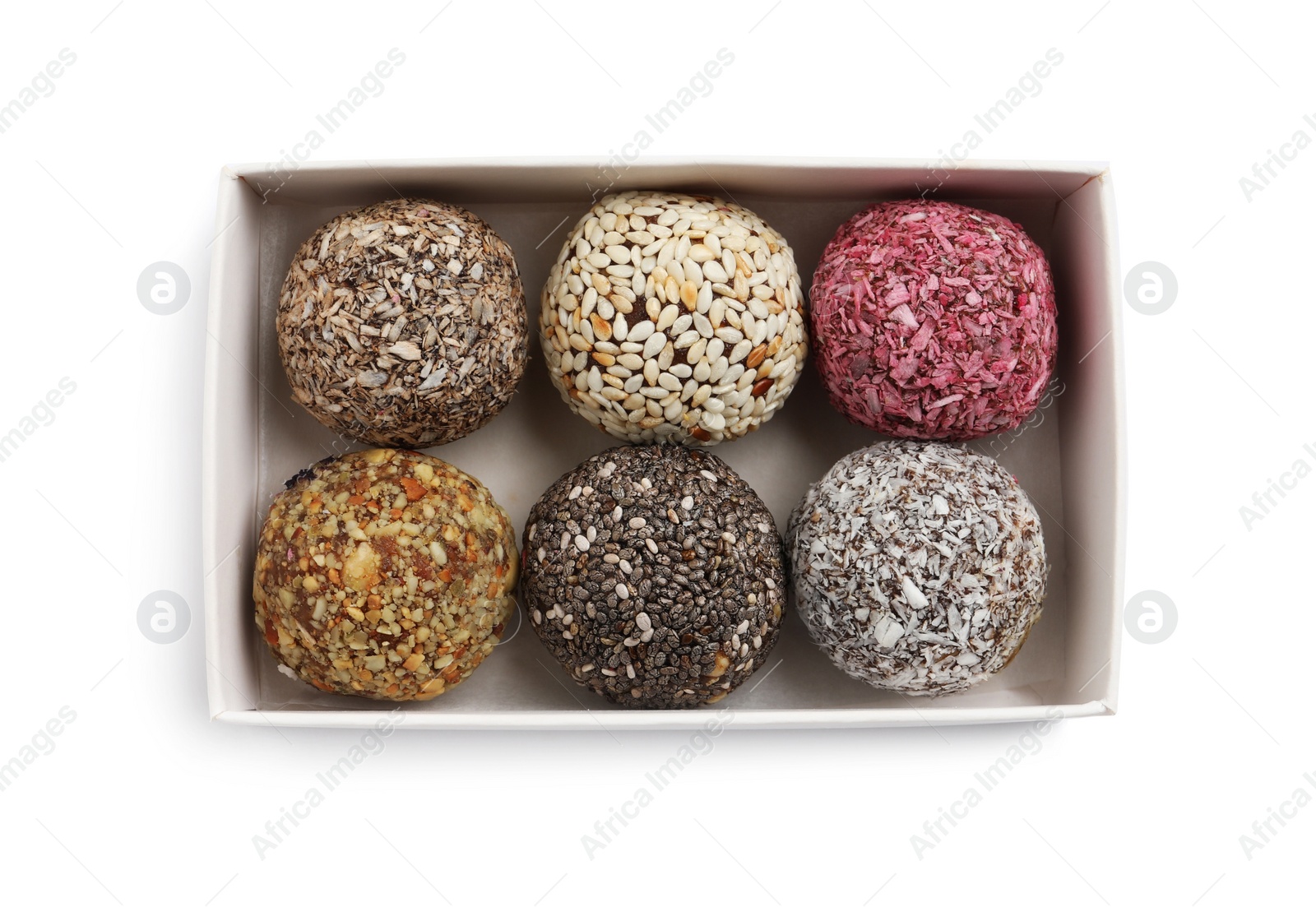 Photo of Different delicious vegan candy balls in box on white background, top view