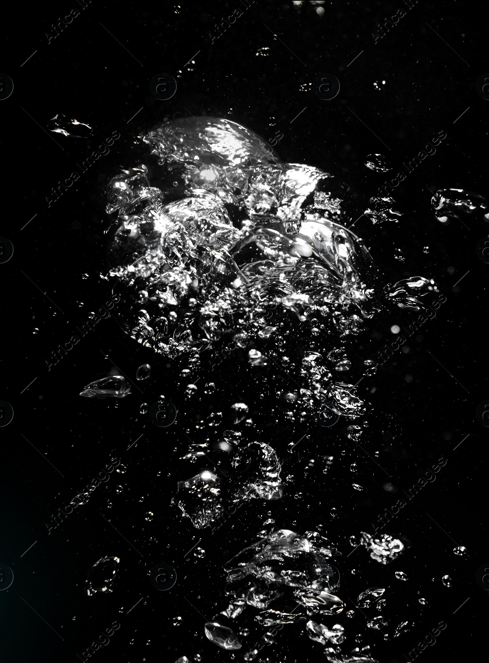 Image of Many air bubbles in water on black background