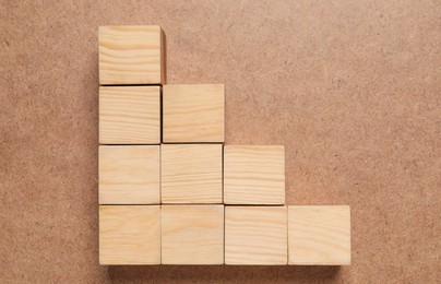 Photo of Many cubes on wooden background, flat lay. Management concept