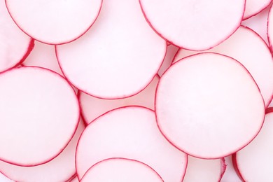 Slices of fresh ripe radish as background, top view