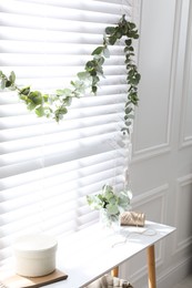 Photo of Stylish room decorated with beautiful eucalyptus garland