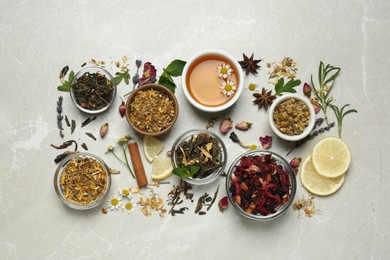 Flat lay composition with fresh brewed tea and dry leaves on light table