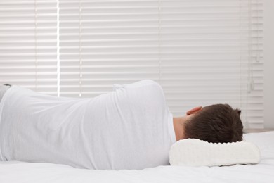 Photo of Man sleeping on orthopedic pillow at home