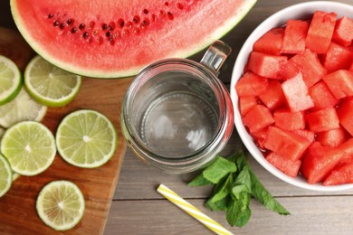 Fresh ingredients for making watermelon drink with lime on wooden table, above view