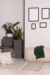 Photo of Empty frames hanging on white wall in stylish room
