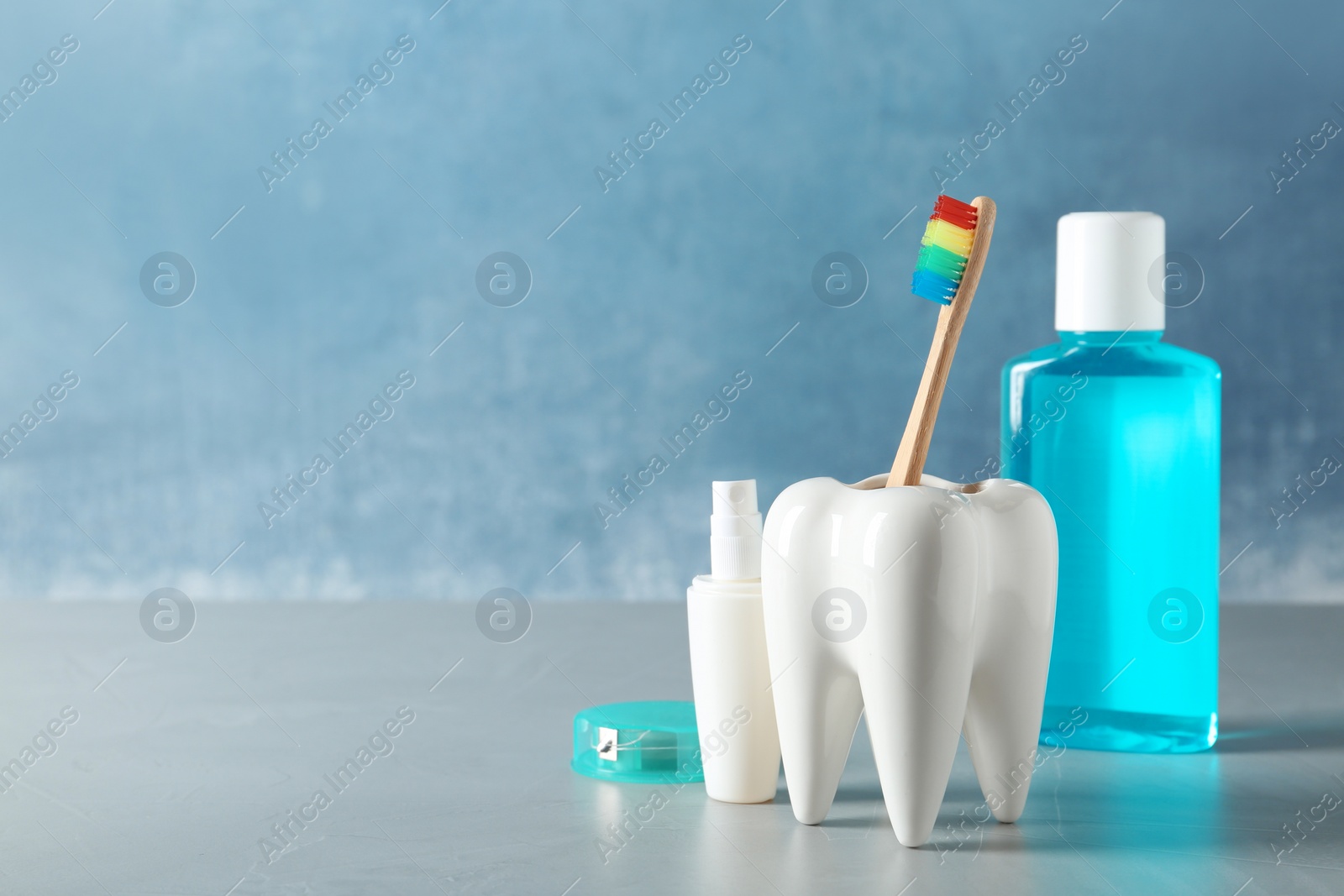 Photo of Composition with oral care items on table against color background, space for text. Healthy teeth