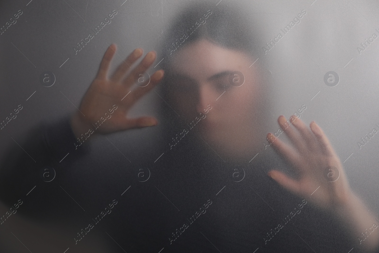 Photo of Silhouette of ghost behind fabric against light grey background
