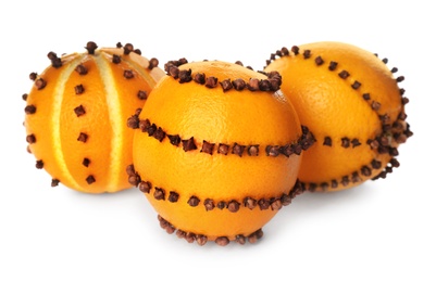 Pomander balls made of fresh oranges and cloves on white background