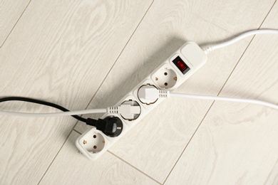 Photo of Extension cord on floor, top view. Electrician's professional equipment