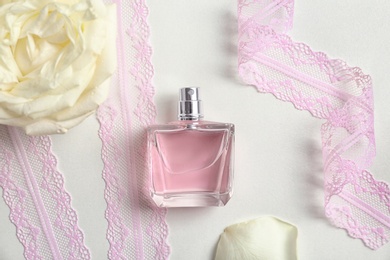 Beautiful composition with bottle of perfume on white background, flat lay