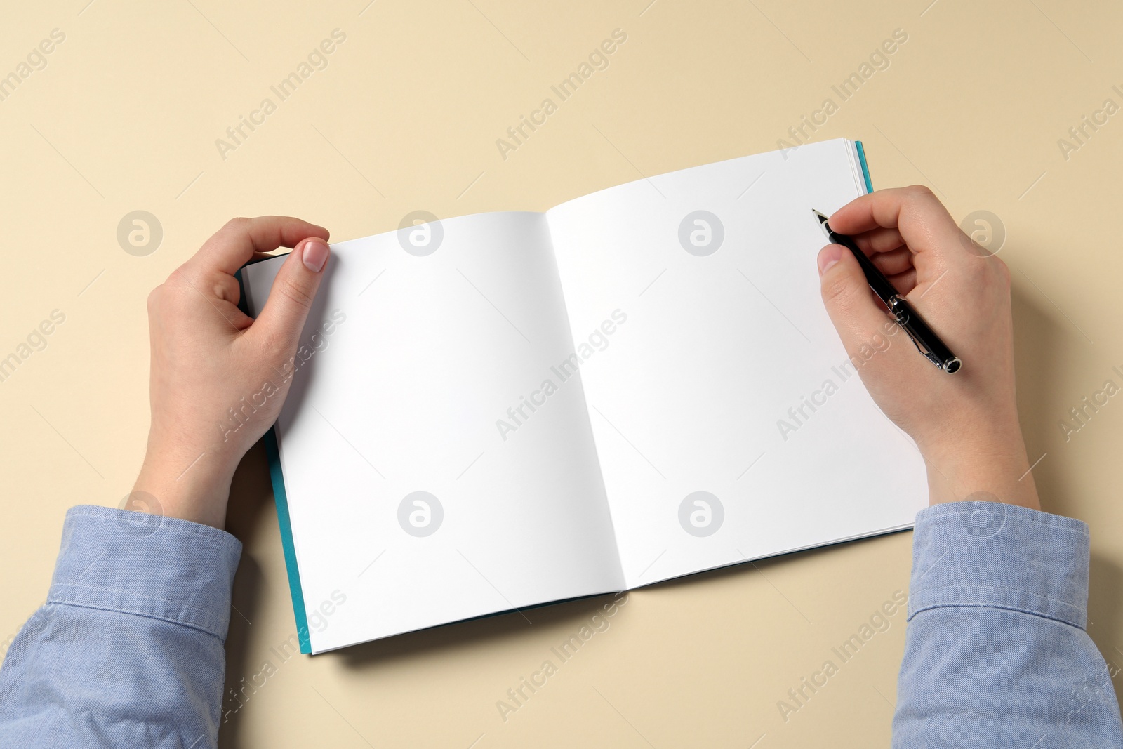Photo of Man with pen and notepad on beige background, top view
